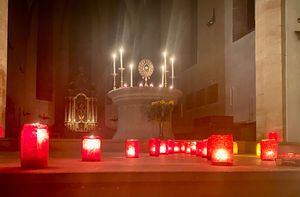View of the altar with the Blessed Sacrament and many candles in front of it