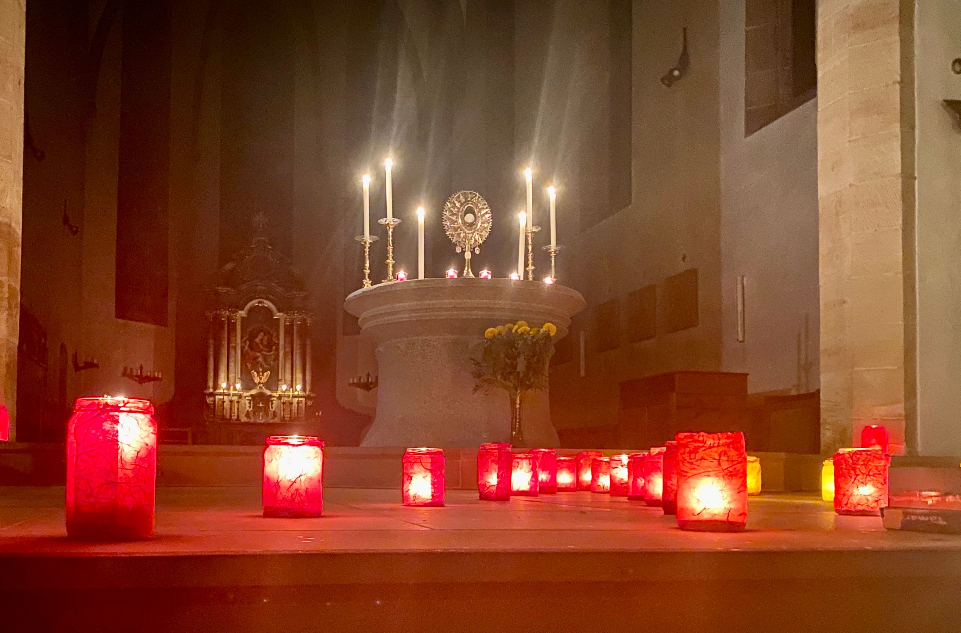 View of the altar with the Blessed Sacrament and many candles in front of it