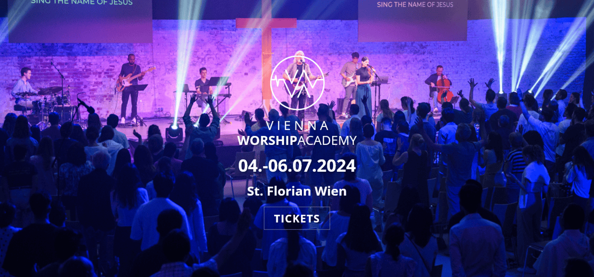 Vienna Worship academy, Lobpreis Wien, Christian, Catholic, band singing on stage while crowd cheers, image is tinted blue and purple
